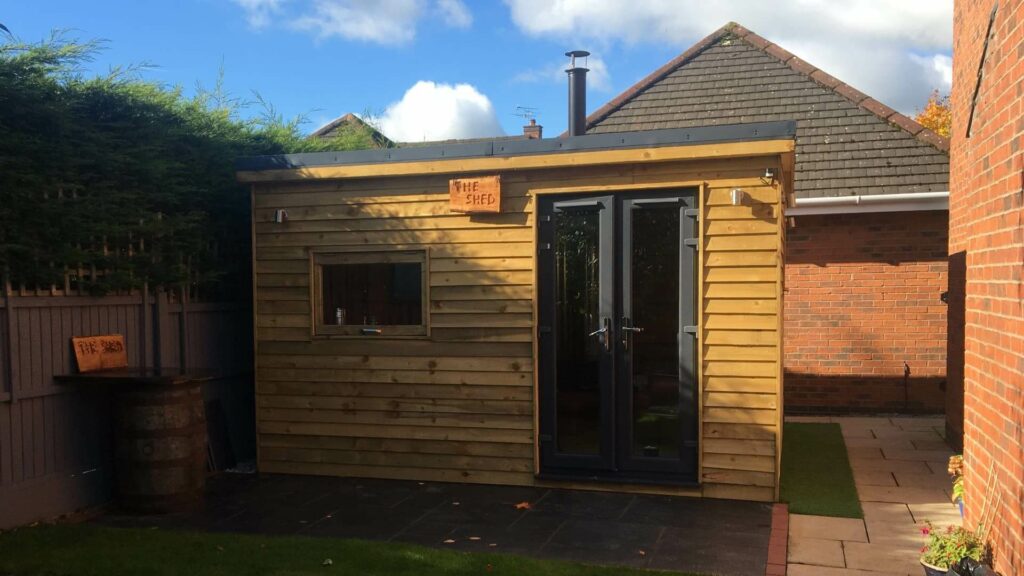 Exterior of a garden room showing the flue of a wood burning stove