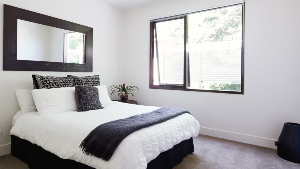 Guest bedroom showing a bed in front of a window
